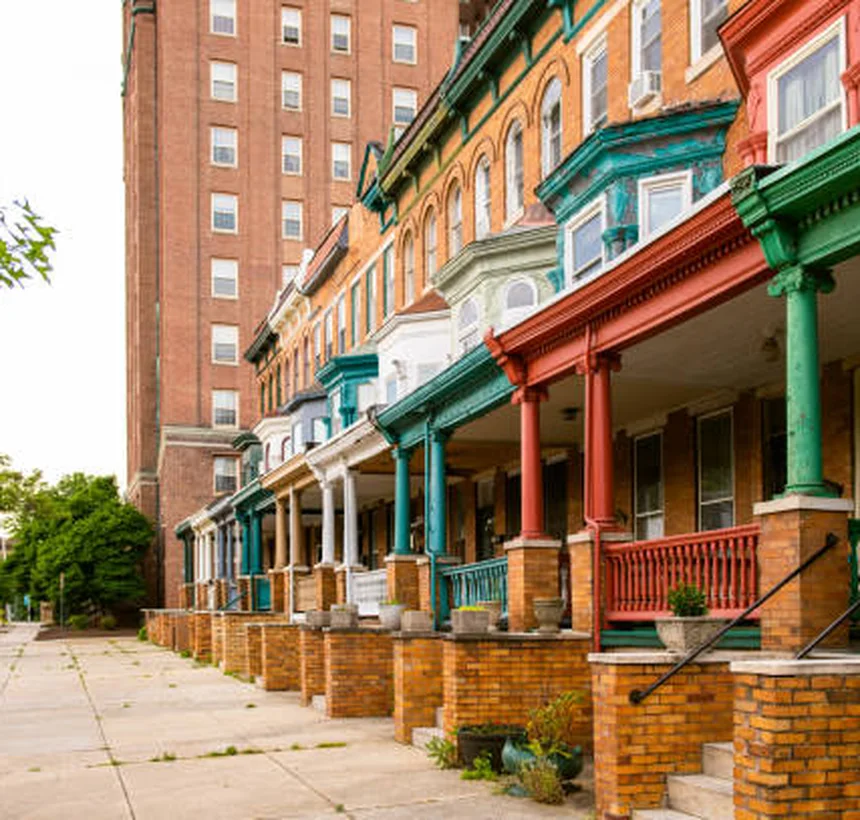 Colorful Baltimore rowhomes with front porches on a city block
